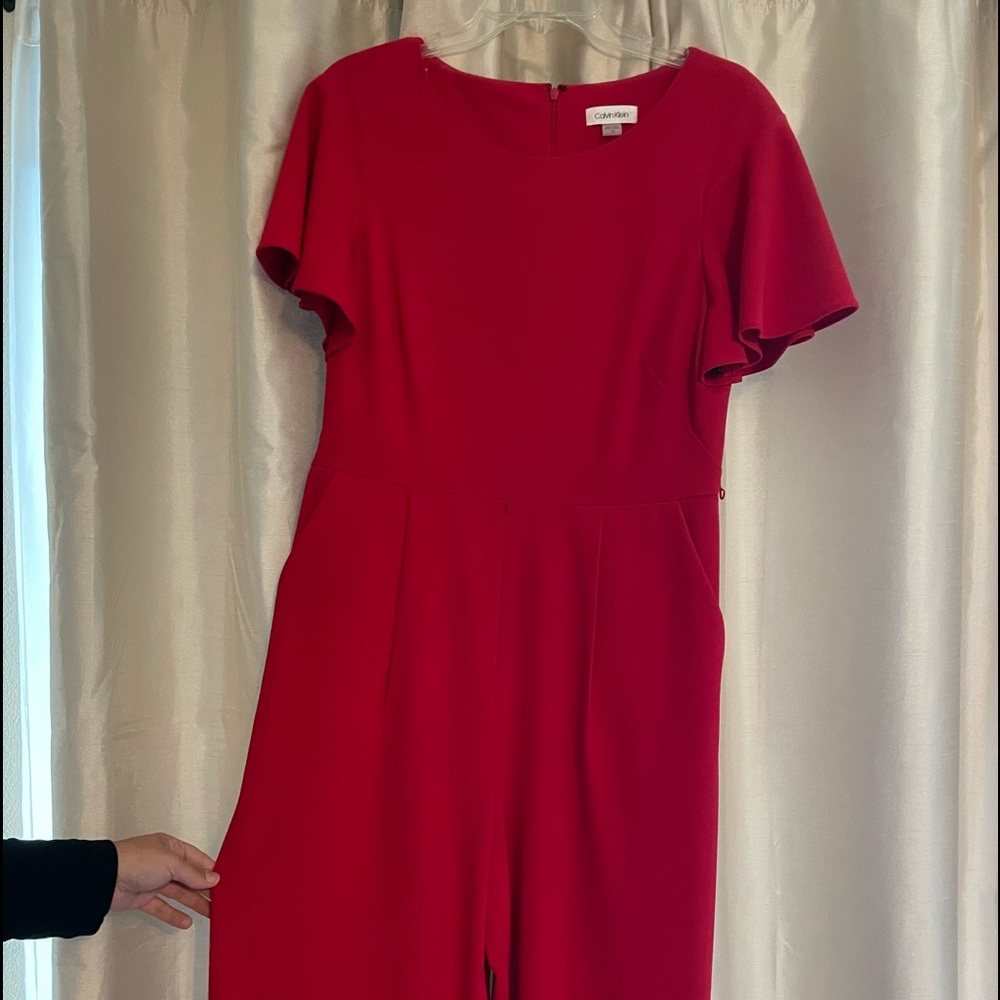 A red jumpsuit size 12 and is in perfect condition!